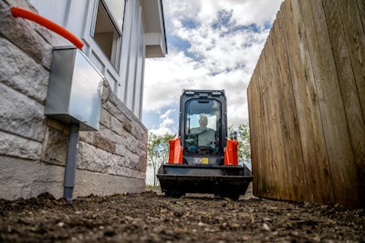 Kubota SVL50x CTL between privacy fence and home