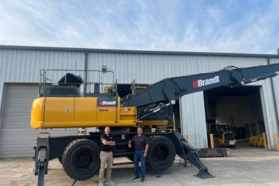 men in front of a brant material handler