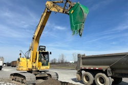 werk-brau reverse v line bucket on excavator raised above truck