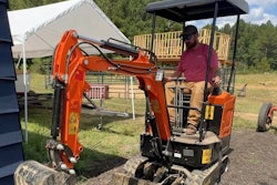 AHM AX-15 mini excavator digs near a house