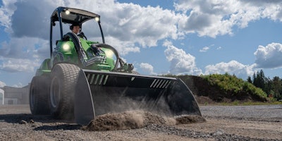 Avant Tecno 855i compact wheel loader with bucket pushing dirt