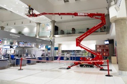 red CMC 65L compact tracked aerial lift outreach in building