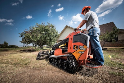 man on Ditch Witch SK800 mini track loader with tilling attachment