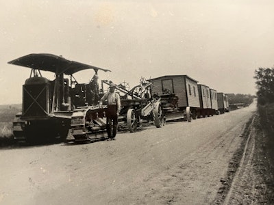 old black and white photo Cat 60 pulling grader and bunk wagons