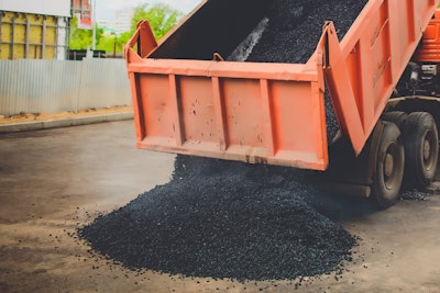 Dump Truck unloading asphalt