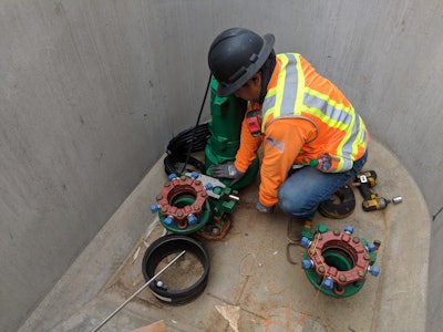 construction worker installing a pipe