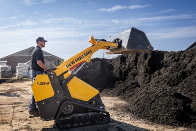 New Holland C314 mini track loader with bucket at soil pile