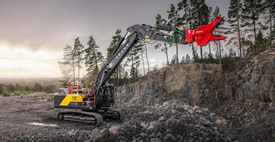 Volvo EC400 excavator boom arm extended with red crusher jaw attachment