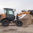 a case electric compact wheel loader moves dirt