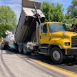 a truck pours asphalt