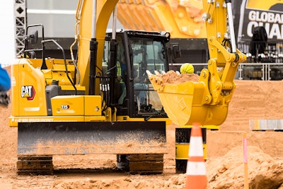 Cat excavator with full bucket and yellow ball on top