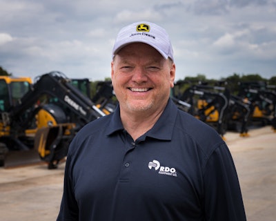 Dennis Howard in front of construction equipment