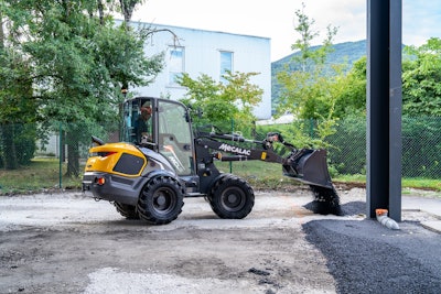 MECALAC MCL8 compact wheel loader dumping asphalt