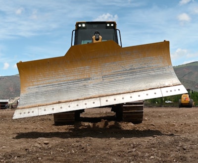 Track loader with tilted dozer blade
