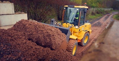 Volvo L30 Compact Wheel Loader pushing dirt onto dirt hill