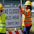 scdot workers put up road closed sign