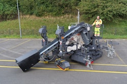 man operates a wirtgen sp 33 paver