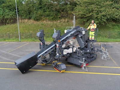 man operates a wirtgen sp 33 paver