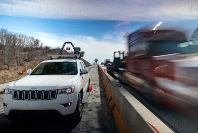 trucks drives through work zone