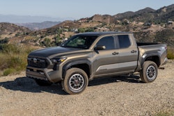 2025 Toyota Tacoma TRD OffRoad bronze oxide color on dirt road mountain background