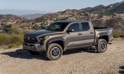 2025 Toyota Tacoma TRD OffRoad bronze oxide color on dirt road mountain background