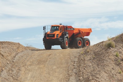 DEVELON da45 dump truck at top of dirt road hill