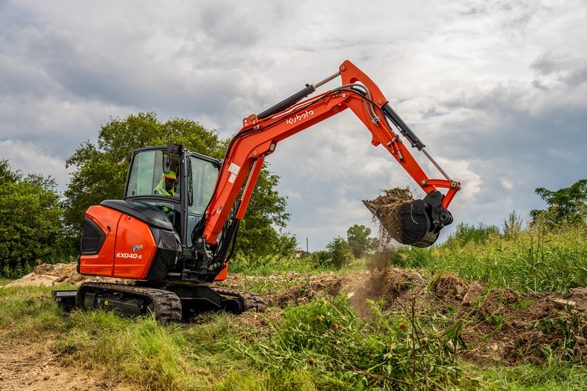 Kubota KX040-5 mini excavator digging in field