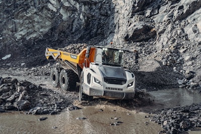 Liebherr TA230 dump truck at bottom of quarry crossing water