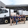 men stand in front of a vac truck