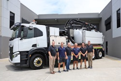 men stand in front of a vac truck