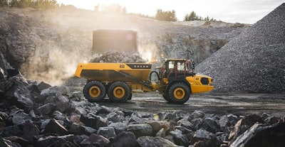 Volvo A50 articulated dump truck being loaded by wheel loader with rocks