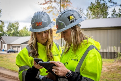 Kayti and Ry using tablets on a construction site