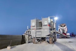 Power Curber 5704-D slipform paver pouring concrete barrier wall on highway under construction