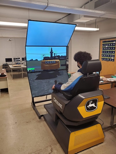 Johnsburg High student operates john deere excavator simulator