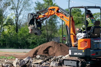 Develon DX17Z excavator picking up rock