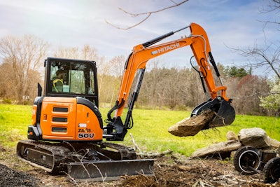 Hitachi ZX50U excavator picking up rock