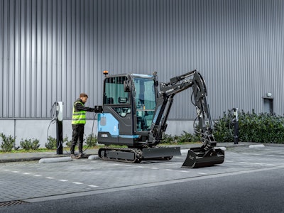 Hyundai HX19e electric mini excavator at a charging station