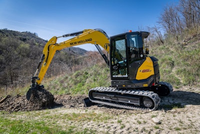 New Holland E85D excavator scooping dirt