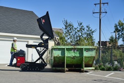 Toro e2250-THL high lift electric ultra buggy dumping into green Dumpster