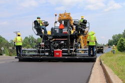 men paving a road