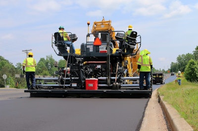 men paving a road
