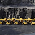 a lineup of volvo dump trucks