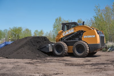 Case SV208 skid steer digging into pile of soil