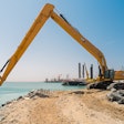 Cat 395 LRE Super Long Reach Excavator dredging a waterway