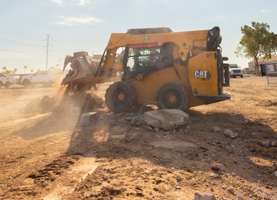 Cat 270 skid steer dumping dirt