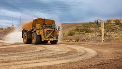 Cat 789D autonomous water truck on a haul road
