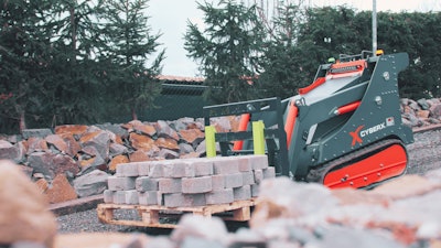 Cyberx mini track loader carrying pallet of bricks
