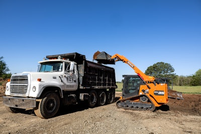 Develon DTL35 compact track loader loading a dump truck