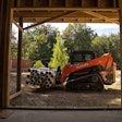 Kubota SVL75-3 compact track loader hauling pipes