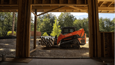 Kubota SVL75-3 compact track loader hauling pipes